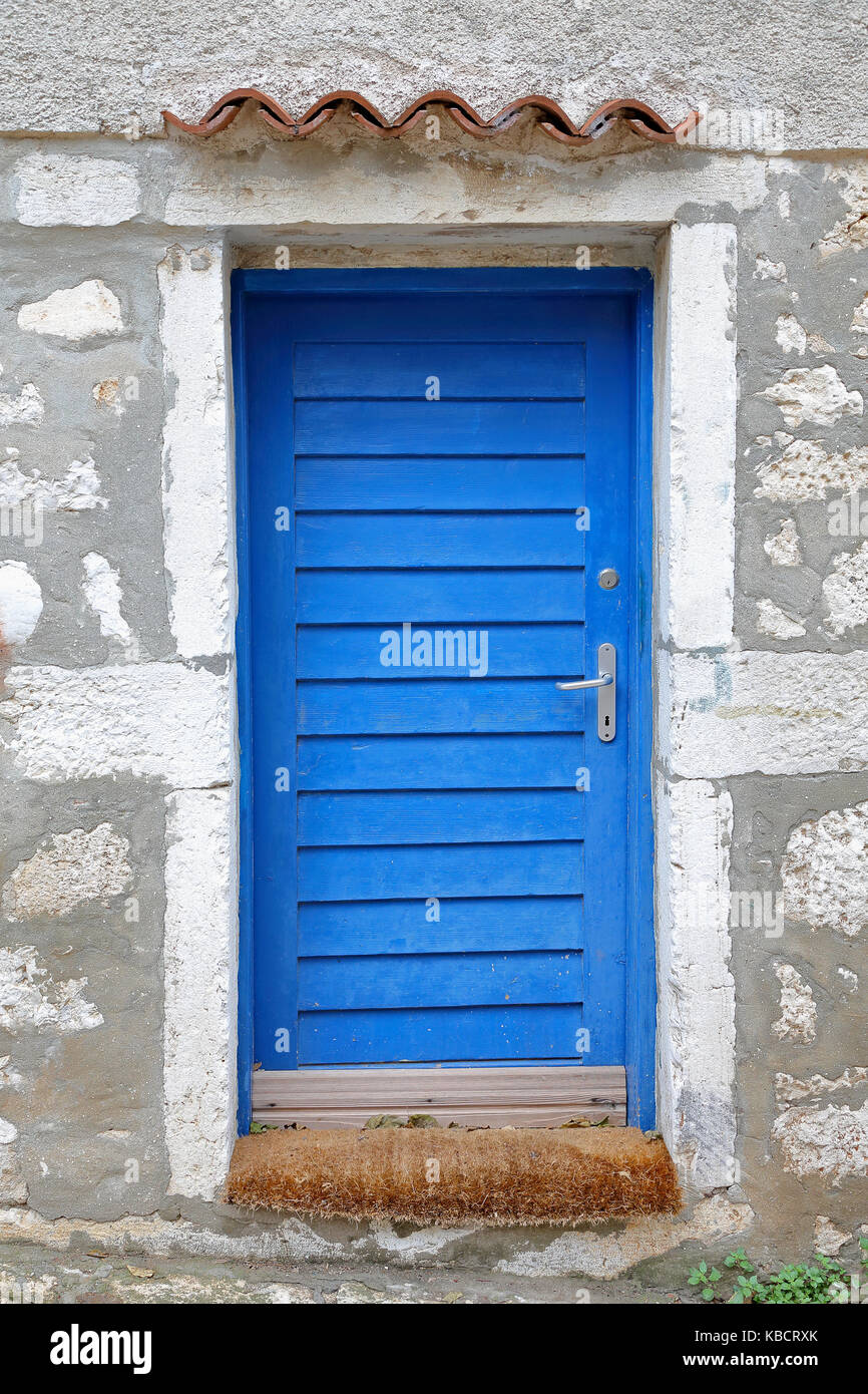 Closed blue door at house exterior Stock Photo