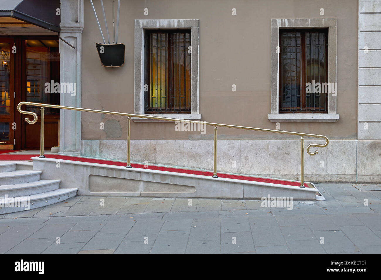 Wheelchair ramp with red carpet for easy access in building Stock Photo