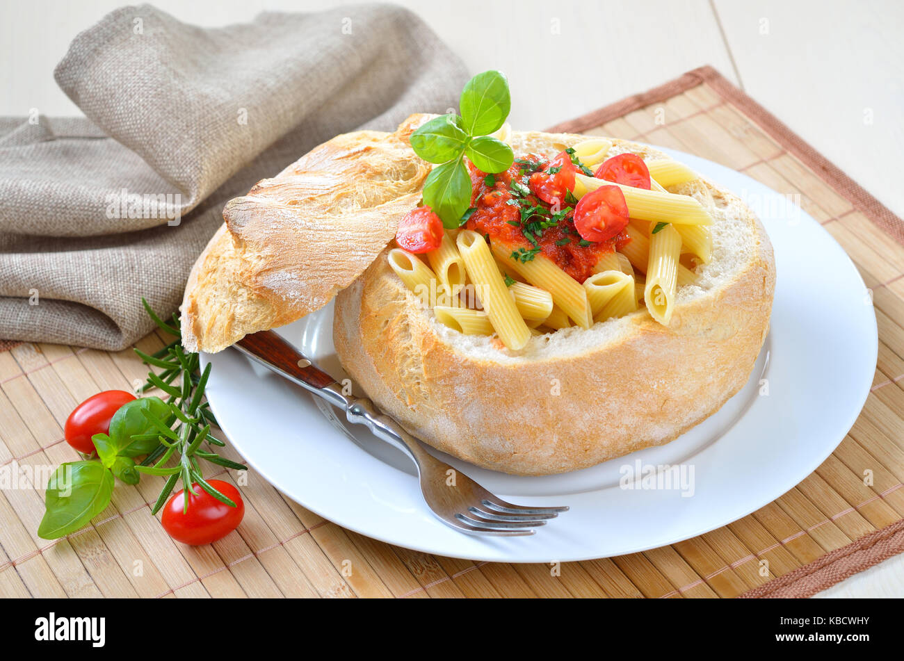 Pasta with tomato sauce filled in Italian ciabatta bread Stock Photo