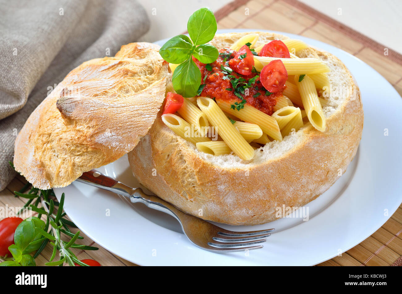 Pasta with tomato sauce filled in Italian ciabatta bread Stock Photo
