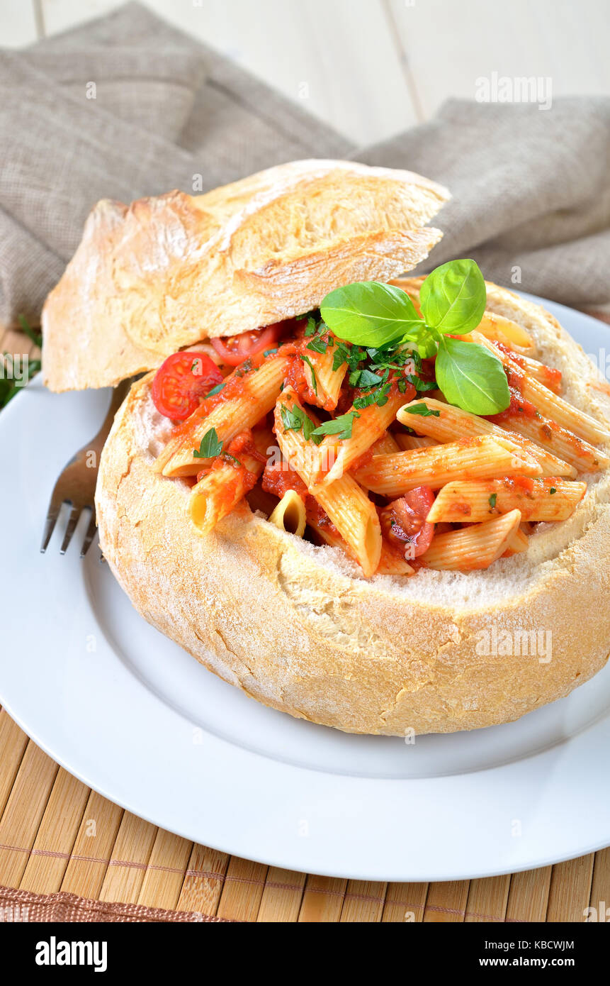 Pasta with tomato sauce filled in Italian ciabatta bread Stock Photo