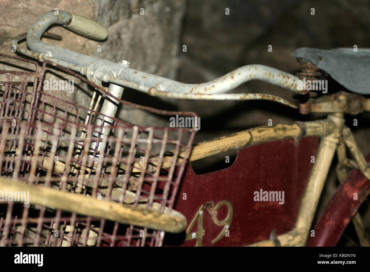 Closeup of oldfashioned bicycle with basket, abandoned in a derelict building Stock Photo Alamy