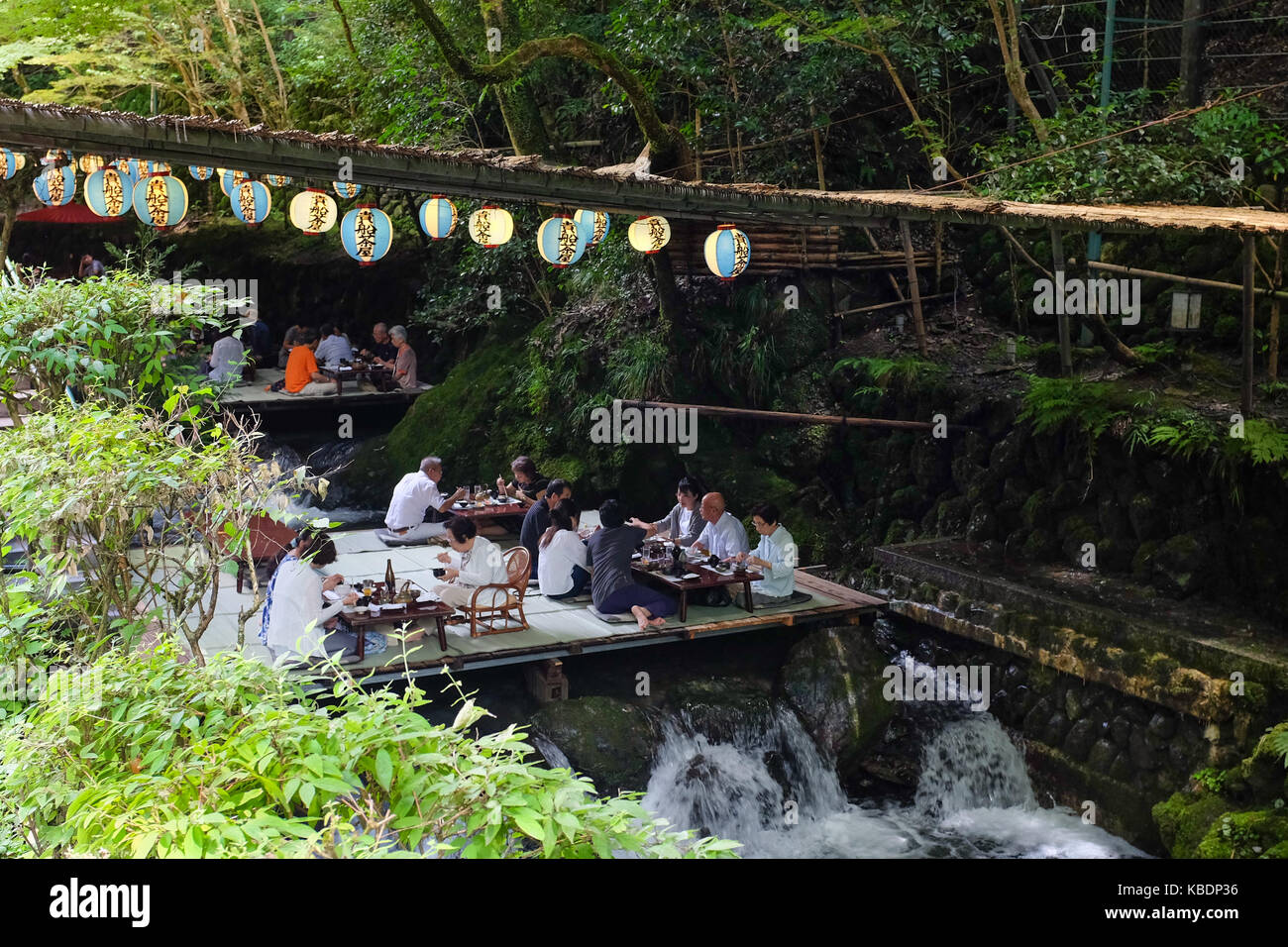 Japan Riverside Dinning Diners enjoying a meal over a river in Kibune, near Kyoto in Japan ...
