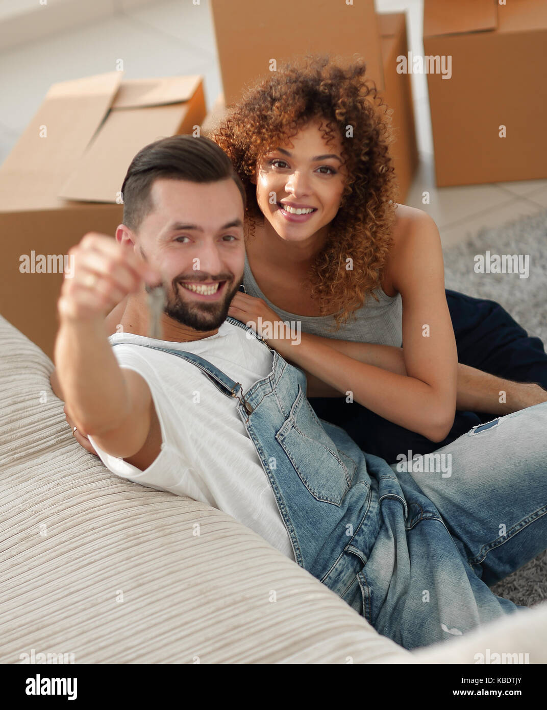 young couple holding the key to a new apartment. Concept of ownership ...
