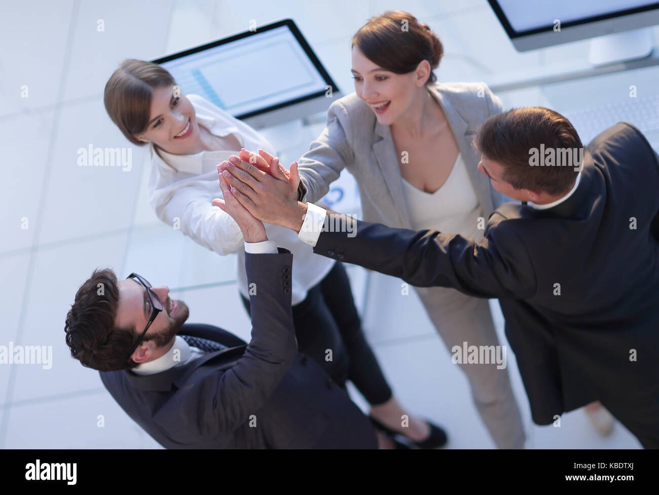 successful business team giving each other a high-five, standing in the ...