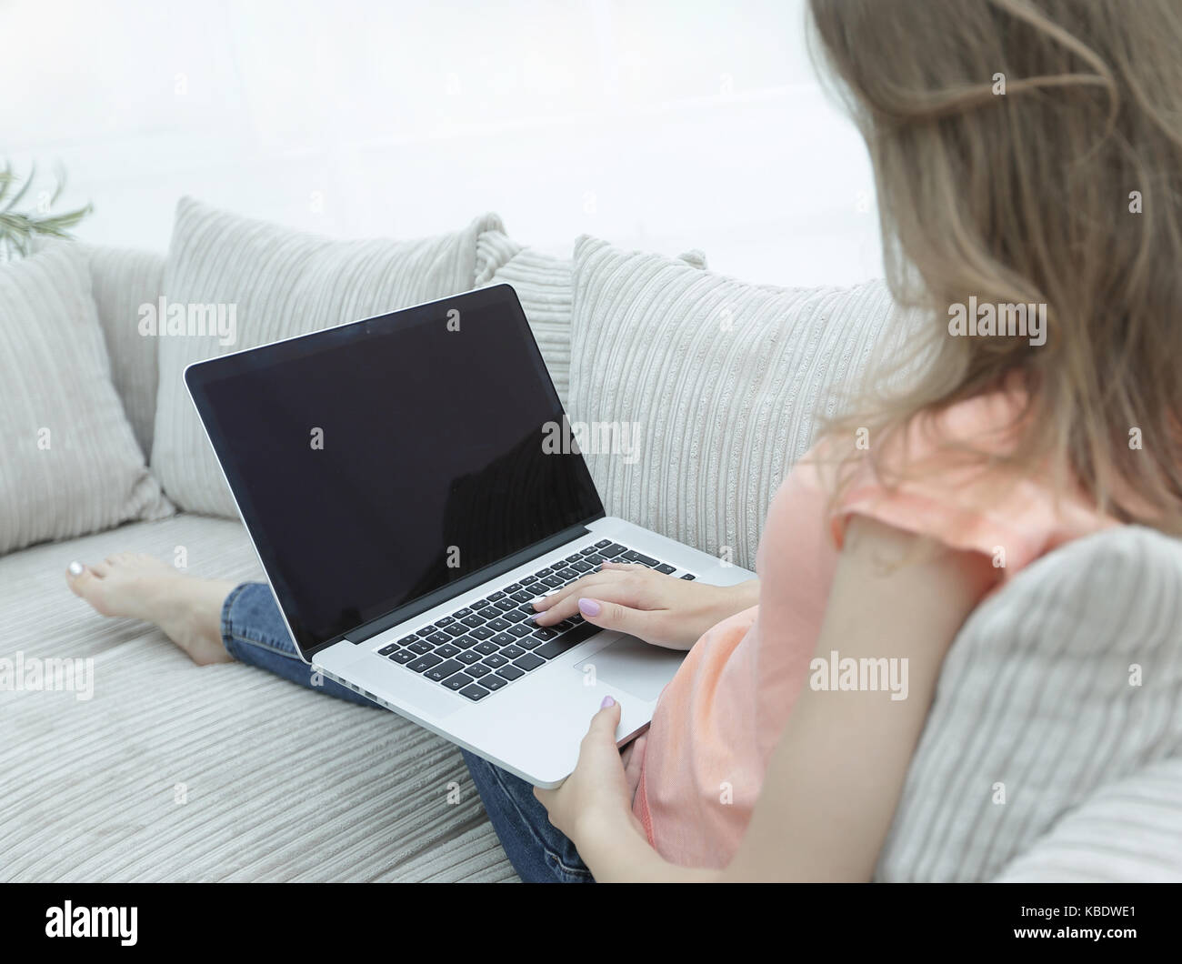 young woman working with laptop sitting on sofa in living room Stock ...