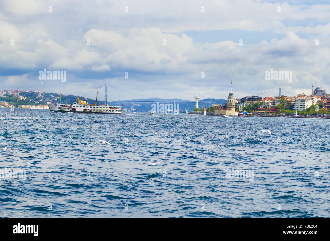 Ferries over the Istanbul Strait, the maiden's tower and the 15th July Martyr's Bridge at the back Stock Photo