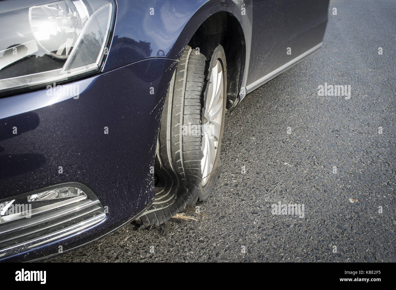 damaged tire after tire explosion at high speed on highway Stock Photo