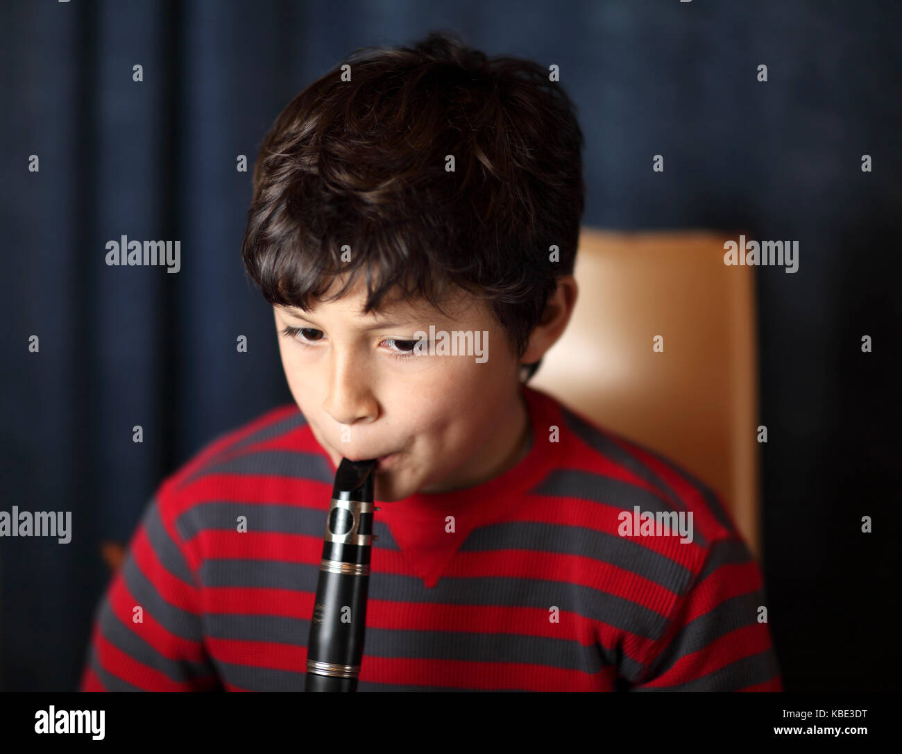 Young boy plays the clarinet Stock Photo