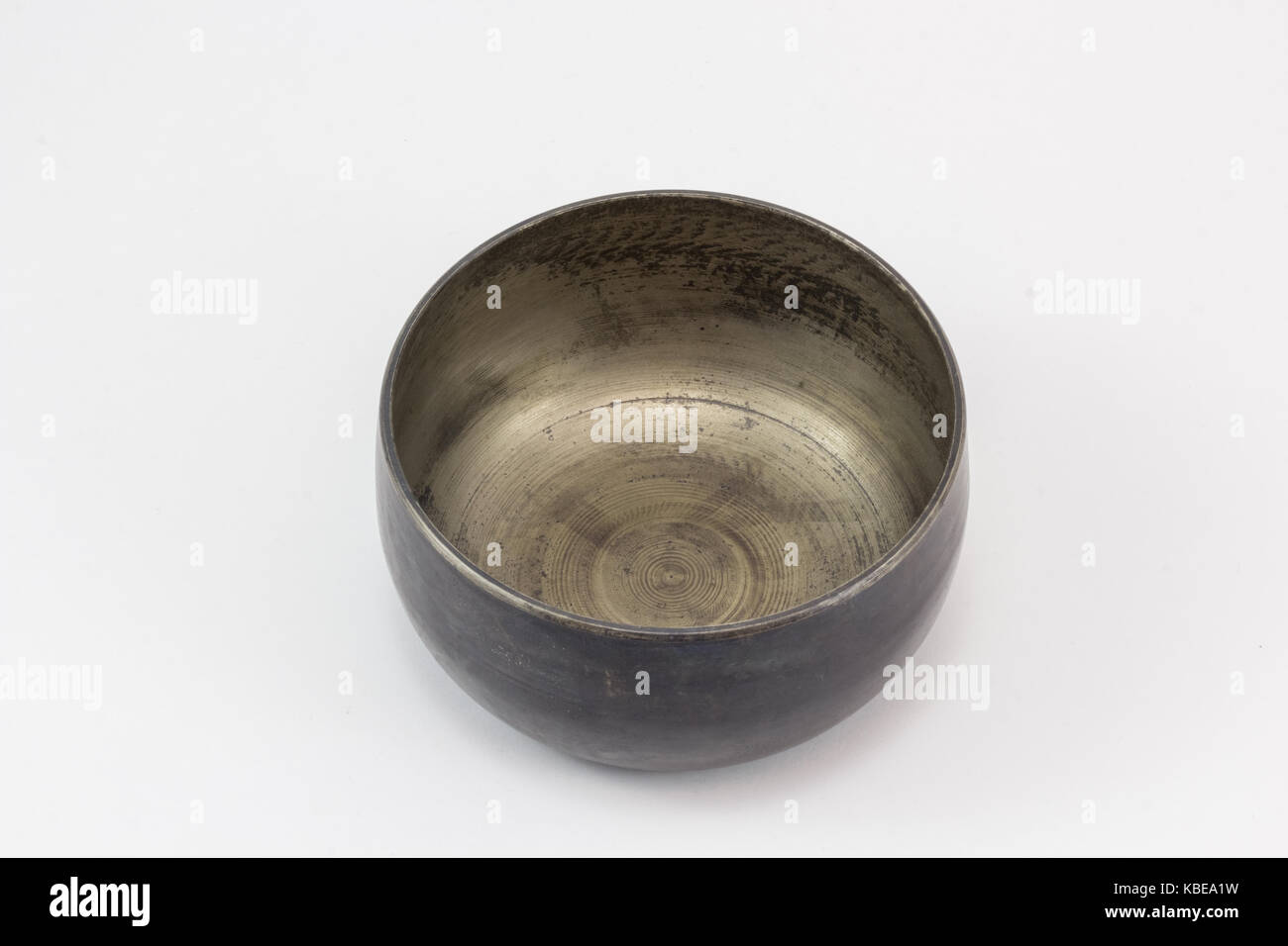 A singing bowl, made of metal, on a white surface Stock Photo Alamy