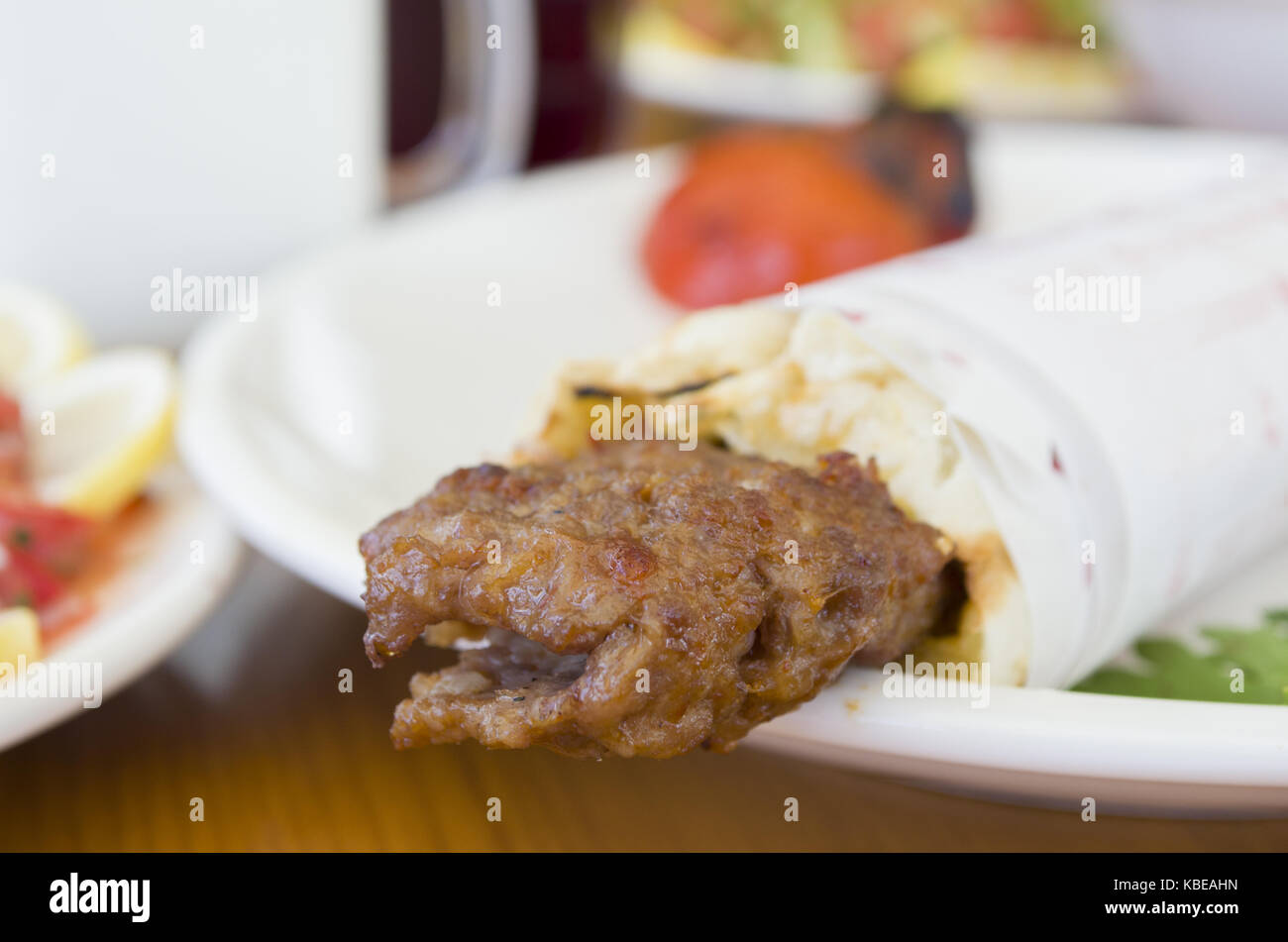 turkish and arabic traditional ramadan adana kebab roll wrap serving with yogurt aubergine salad Stock Photo