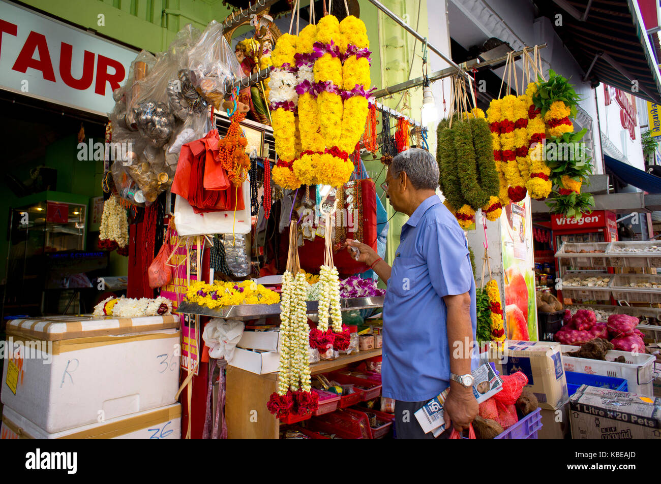 Shop selling garlands of flowers outside a modest restaurant in Little India, centre of the city's large Indian community and one of its most vibran Stock Photo