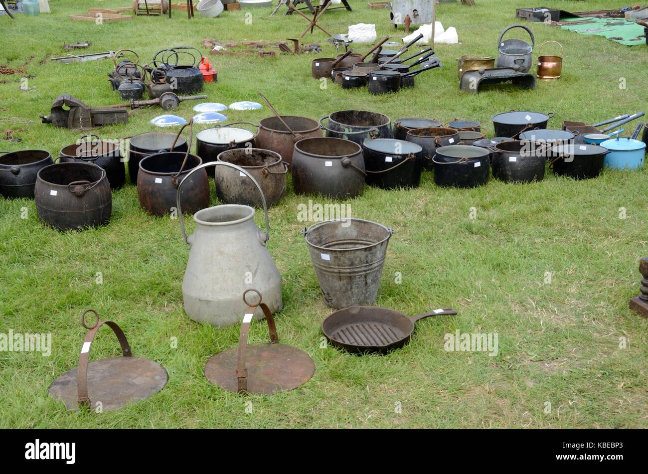 Old cast iron cooking pots and kitchen utensils at a flea market Builth Wells Wales Cymru UK GB Stock Photo