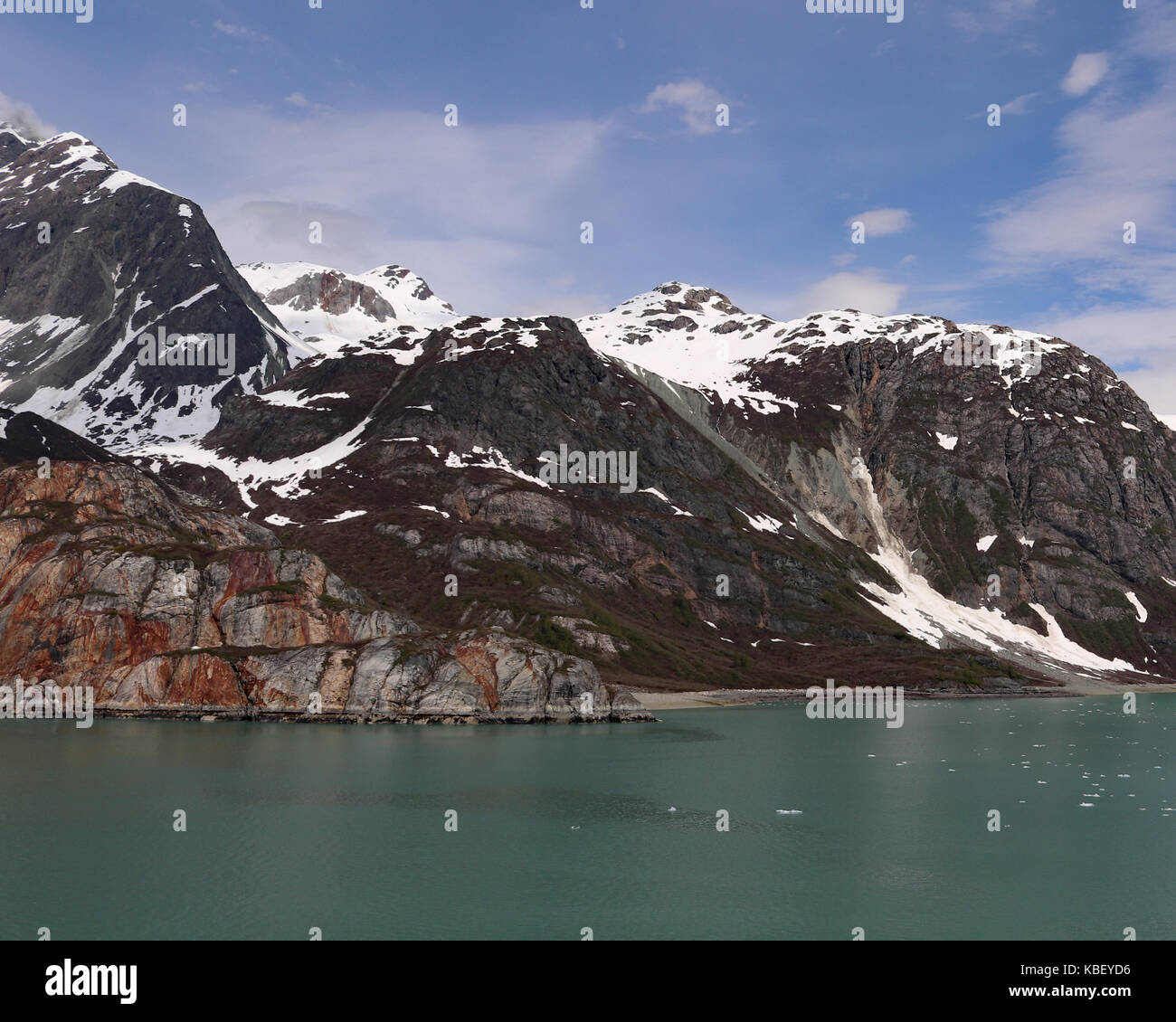 Cruising past beautiful rust colored rocky mountains extending right ...