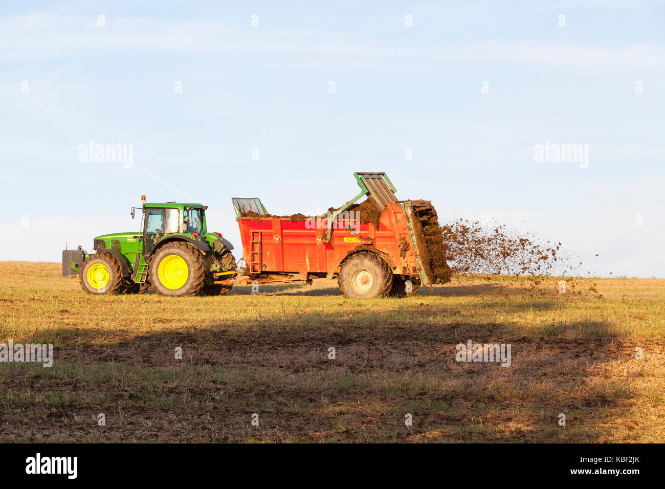 Farmer spreading natural manure from his livestock for organic