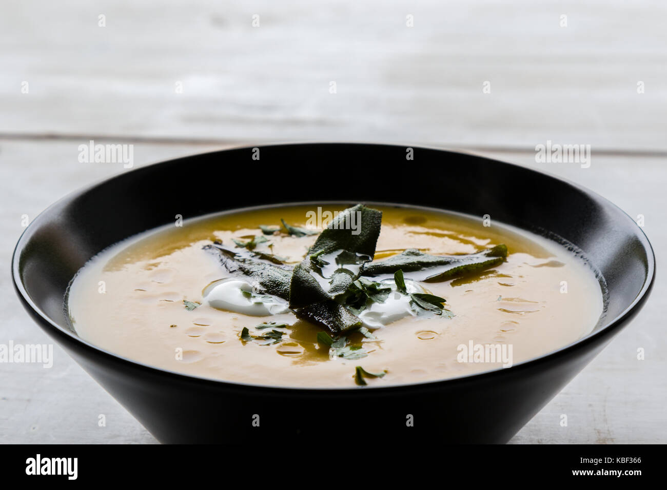 healthy vegetarian pumpkin cream soup in black bowl Stock Photo