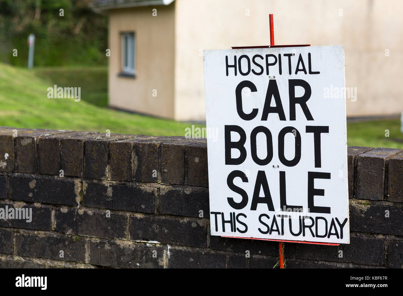 Sign for a car boot sale to raise money for a hospital, illustrating problems such as PFI for hospital finance Stock Photo
