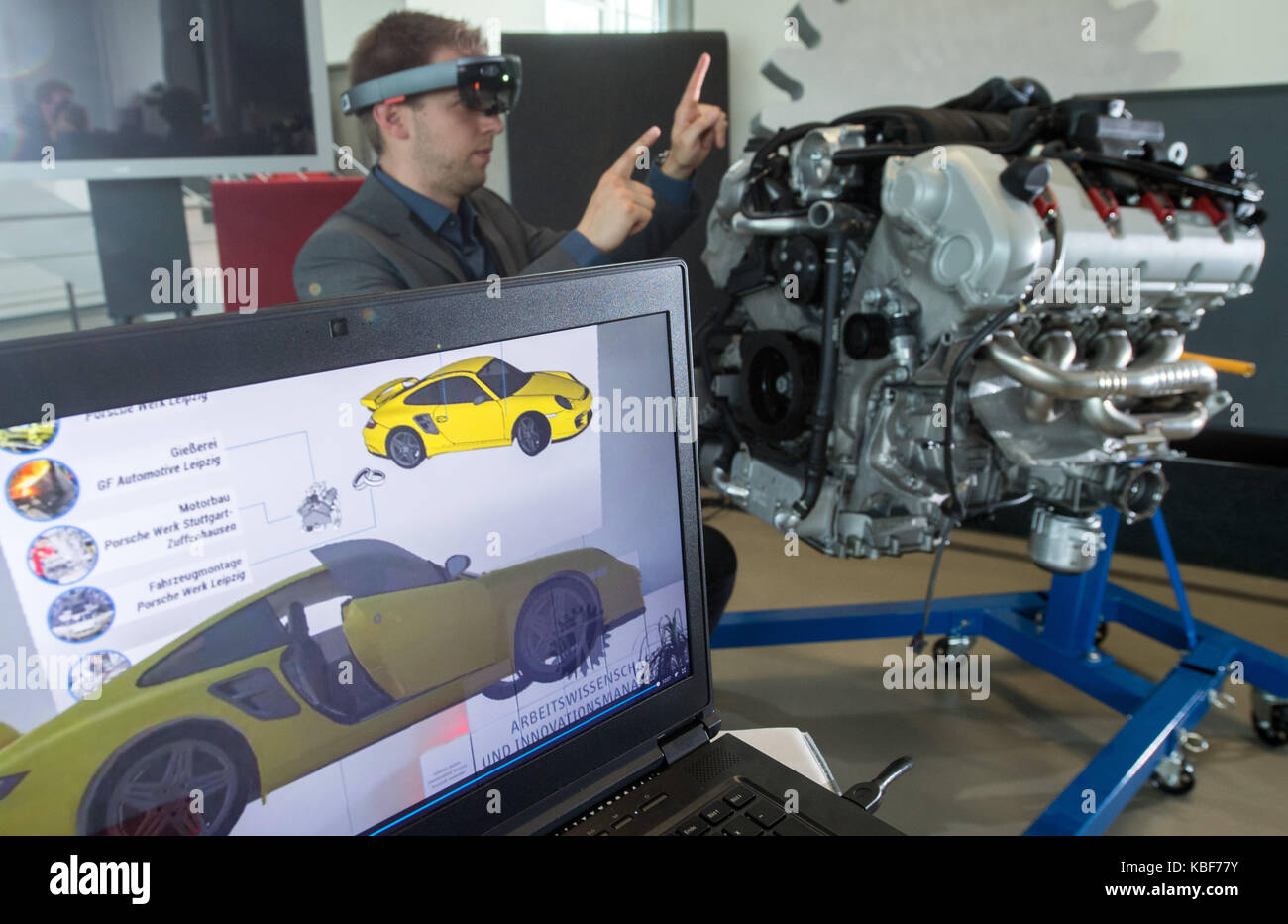 Chemnitz, Germany. 27th Sep, 2017. Scientific assistant Max Bernhagen looks  at a Porsche Panamera V8 motor with augmented reality glasses at the  Technical University in Chemnitz, Germany, 27 September 2017. This and
