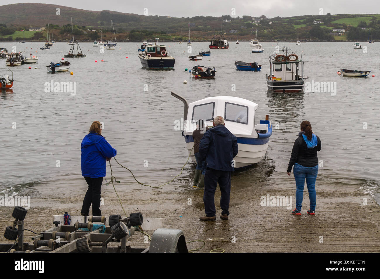 Schull, Ireland. 30th Sept, 2017. Mike Grady of Norfolk based company 'Tactile Boats' hands over a new 'Tactile 21' boat to his customer in Schull, Ireland during a miserable and overcast Saturday morning. Credit: Andy Gibson/Alamy Live News. Stock Photo