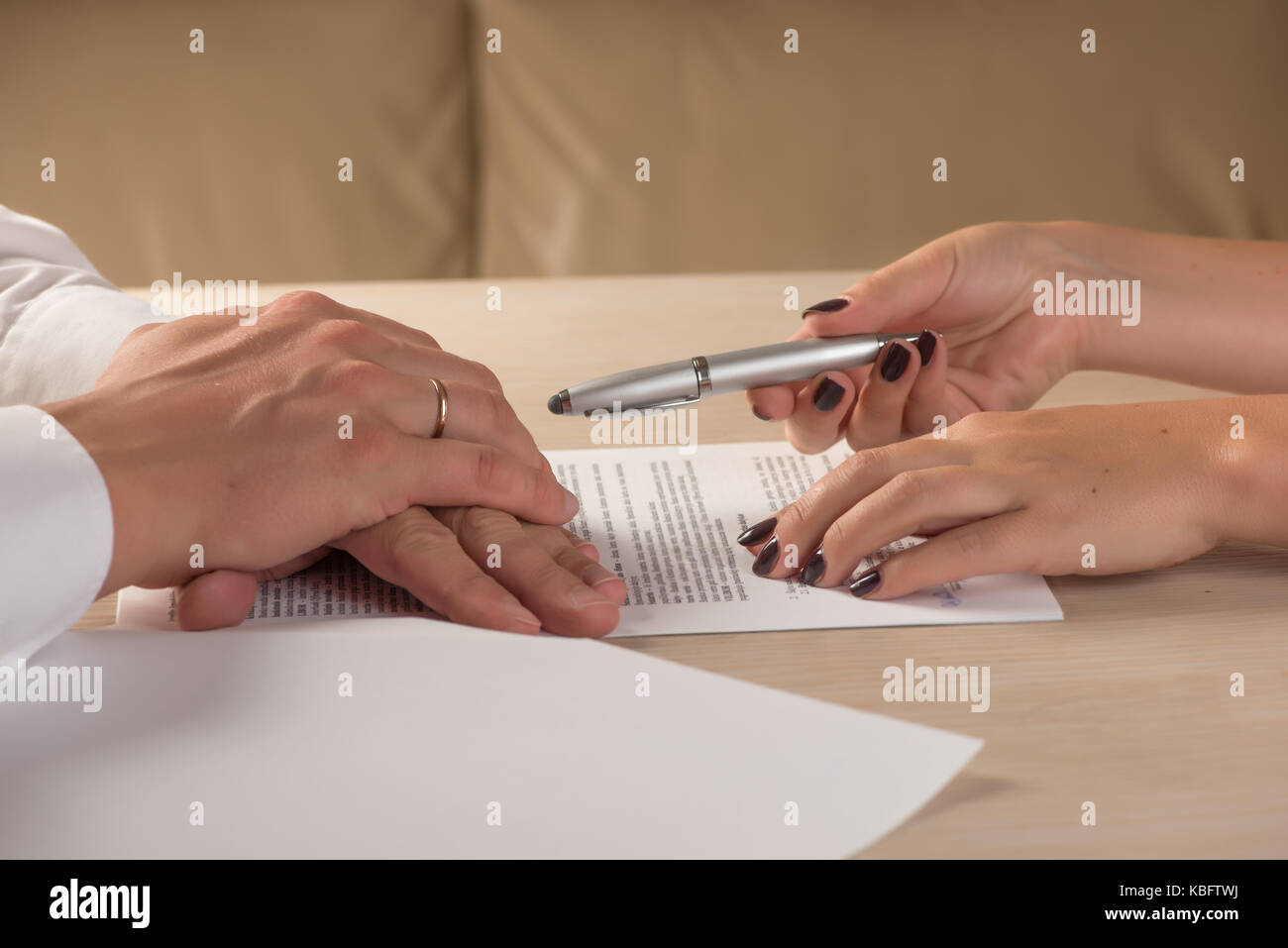 Hands of contractual parties, a woman and a man, signing a contract: business, premarital, loan, mortgage, credit, sales and purchase, investment agre Stock Photo
