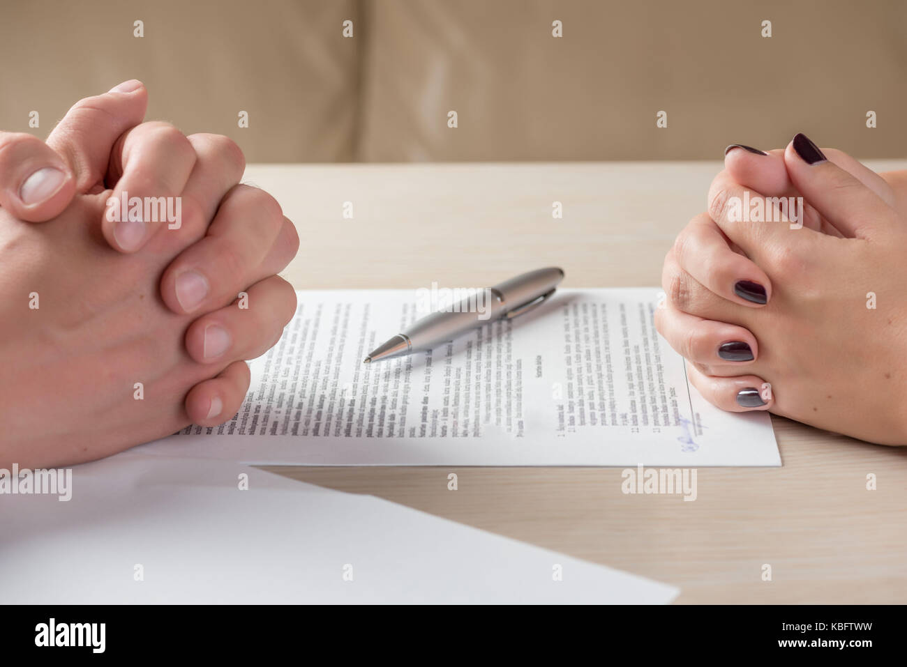 Hands of contractual parties, a woman and a man, signing a contract: business, premarital, loan, mortgage, credit, sales and purchase, investment agre Stock Photo