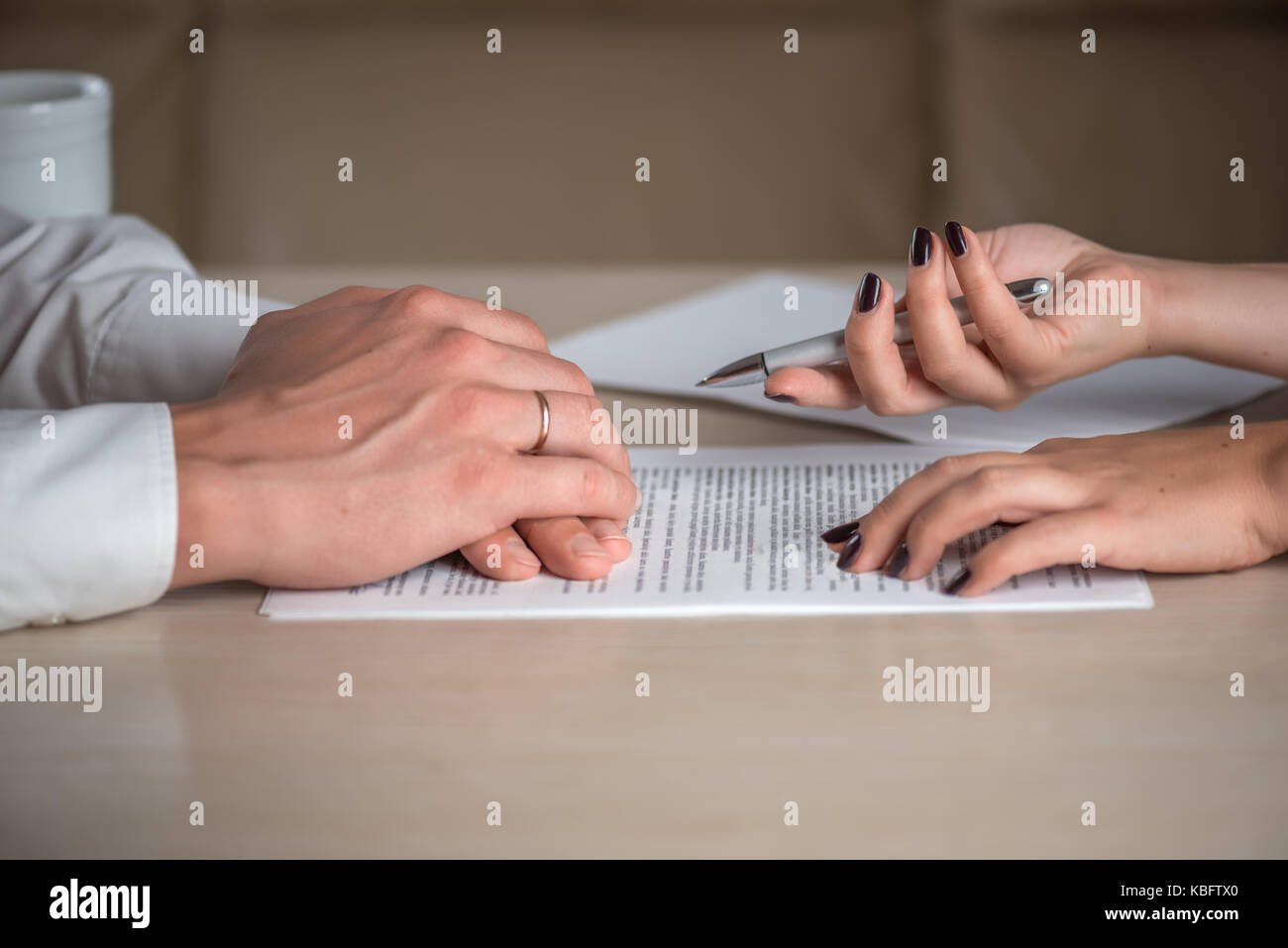 Hands of contractual parties, a woman and a man, signing a contract: business, premarital, loan, mortgage, credit, sales and purchase, investment agre Stock Photo