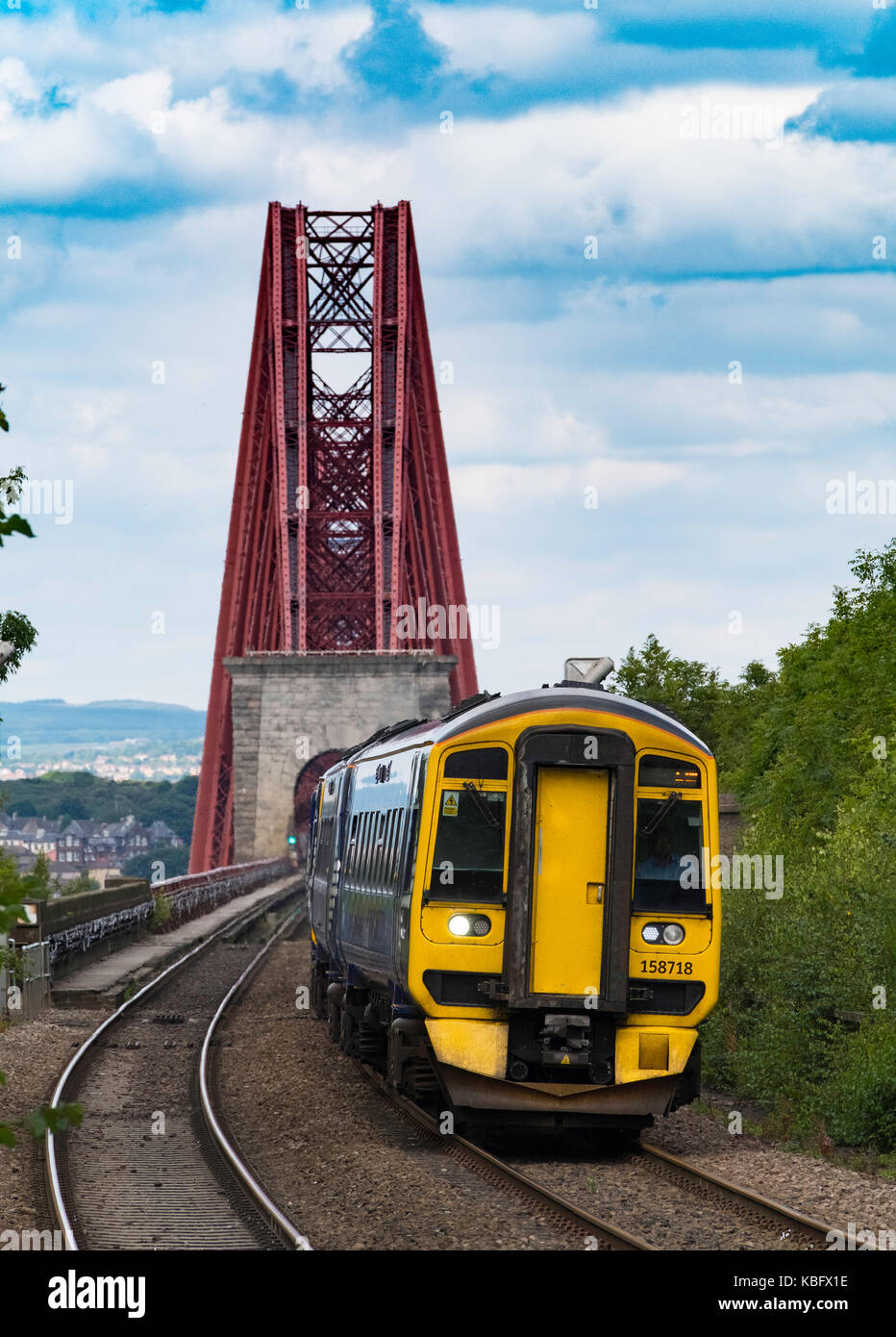 View of Scotrail passenger train approaching Dalmeny Station after crossing Forth Railway Bridge in Lothian , Scotland, United Kingdom. Stock Photo