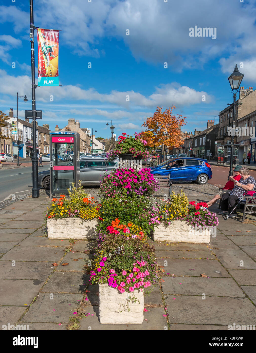 Colourful flower tubs and autumn tints in Galgate in the market town of