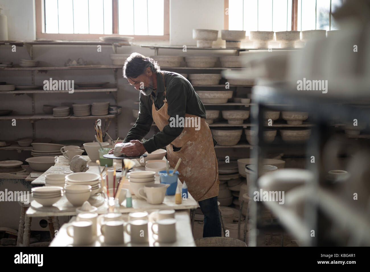 Male potter molding a clay in pottery workshop Stock Photo - Alamy