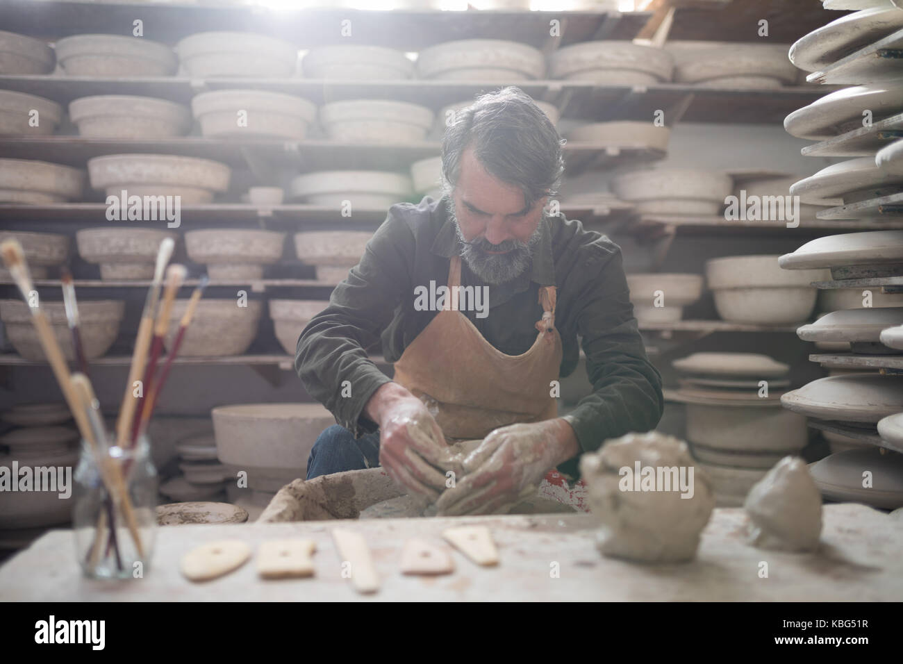 Male potter molding a clay in pottery workshop Stock Photo - Alamy