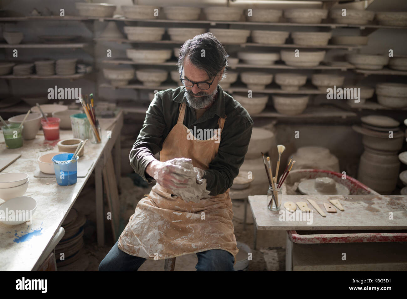 Male potter molding a clay in pottery workshop Stock Photo - Alamy