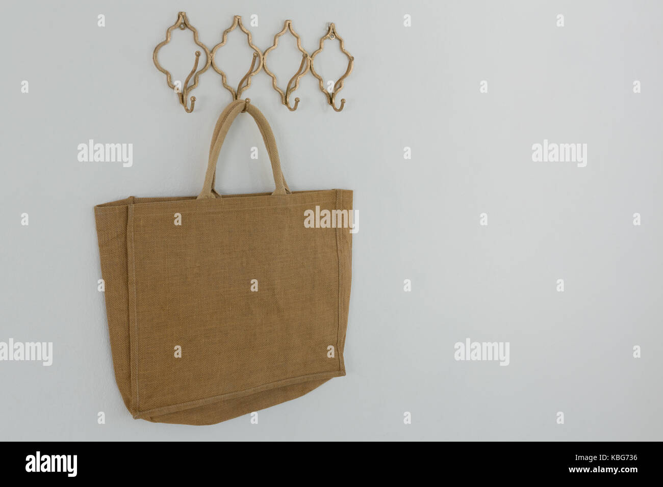 Bag hanging on hook against white wall Stock Photo Alamy