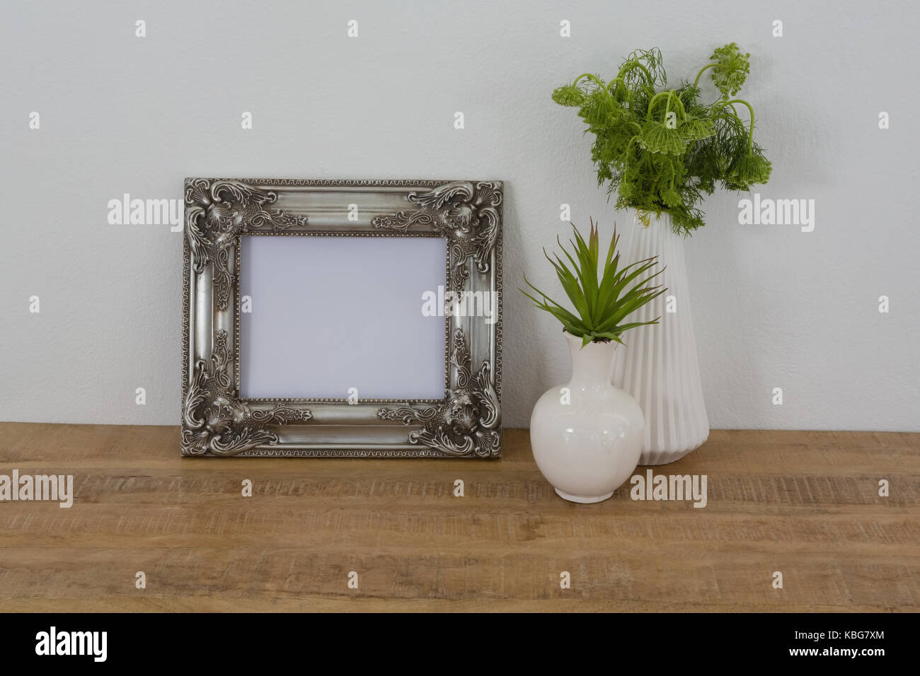 Picture frame and vase arranged on table Stock Photo Alamy