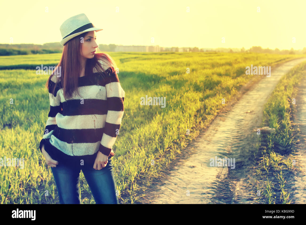 girl in hat fashion field sunset Stock Photo Alamy