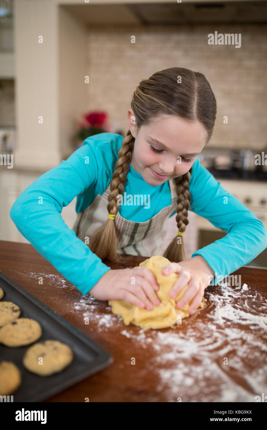 Girl kneading dough in kitchen at home Stock Photo - Alamy