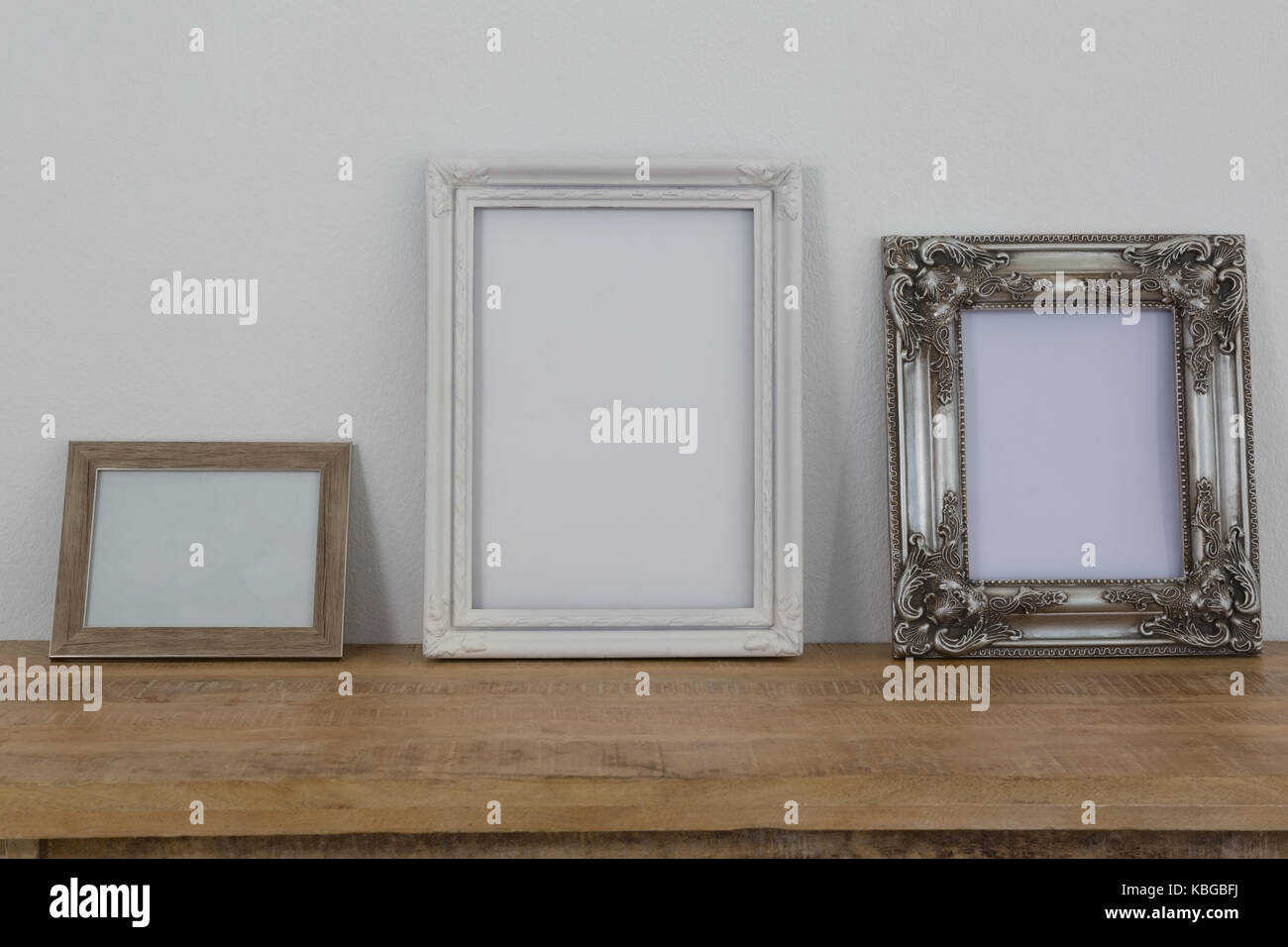 Variety of frames arranged on wooden table Stock Photo Alamy