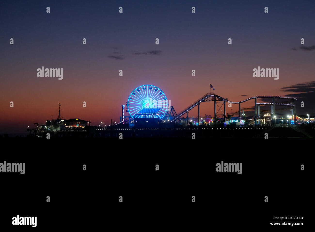 The famous Santa Monica pier and Pacific Park during a summer sunset in Los Angeles, California, USA. Stock Photo