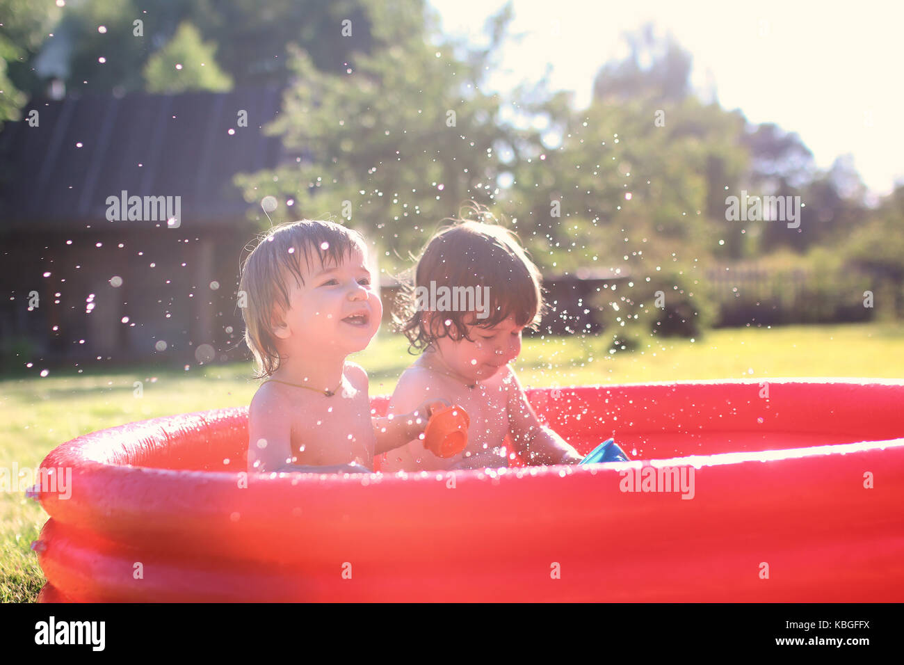 child splashing in the bath outdoors Stock Photo Alamy