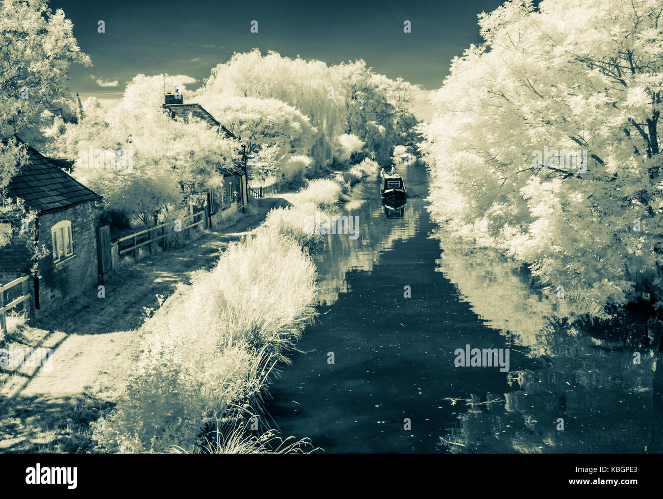 A narrowboat on the Kennet and Avon Canal in Wiltshire shot in infrared and split-toned.. Stock Photo