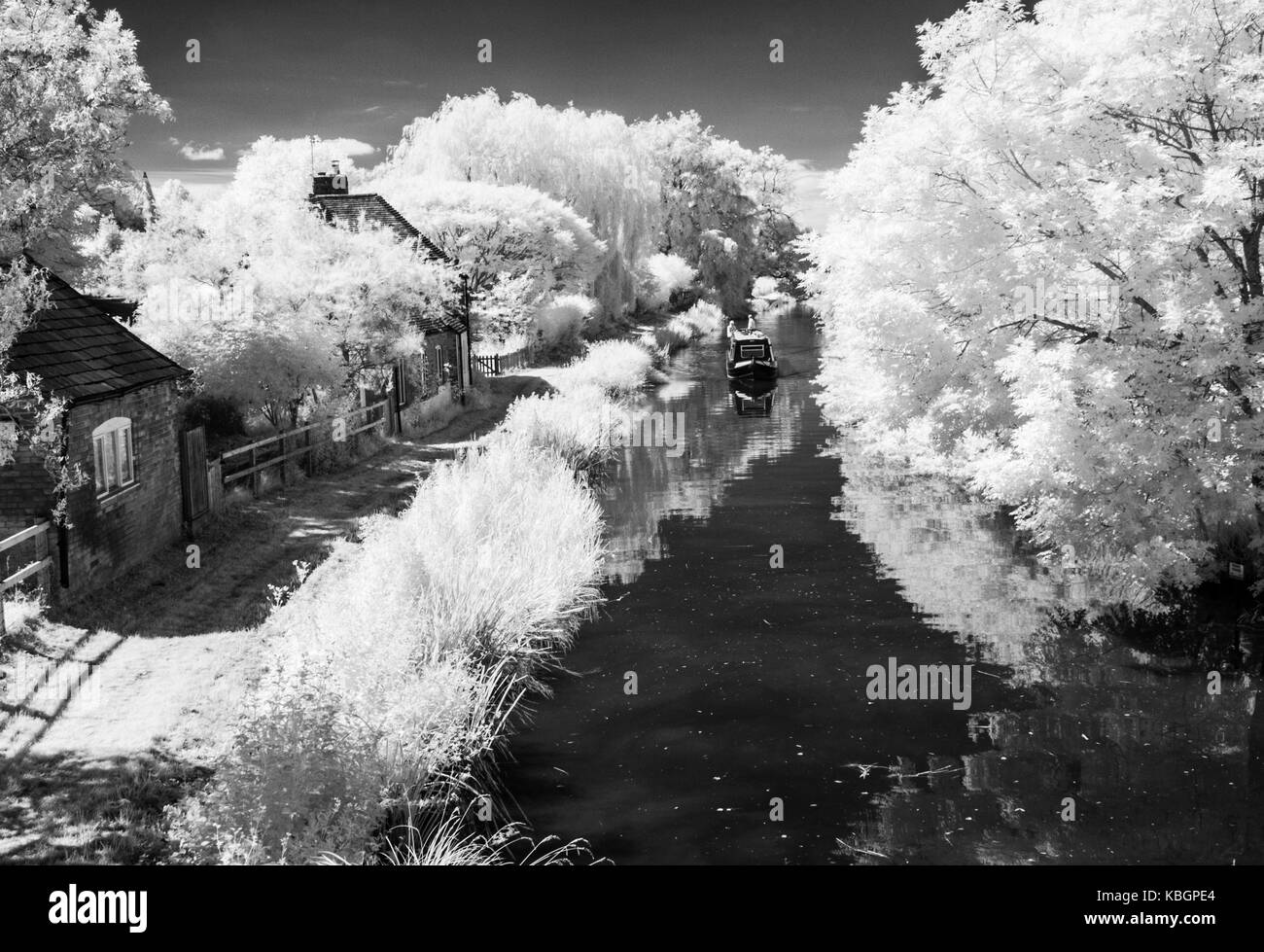 A narrowboat on the Kennet and Avon Canal in Wiltshire shot in infrared. Stock Photo