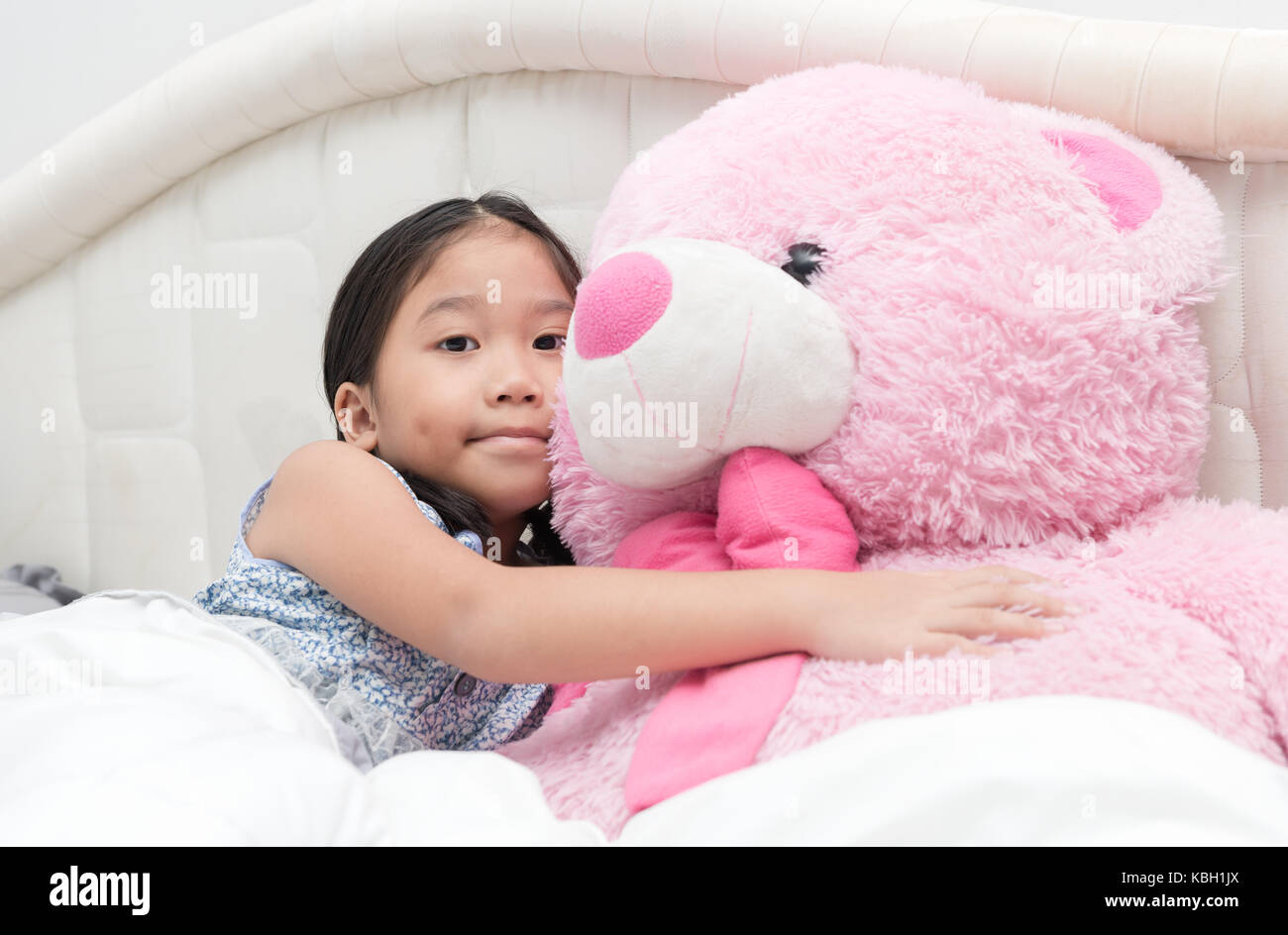 Portrait Of Expressive Cute Asian Little Girl Hugging Big