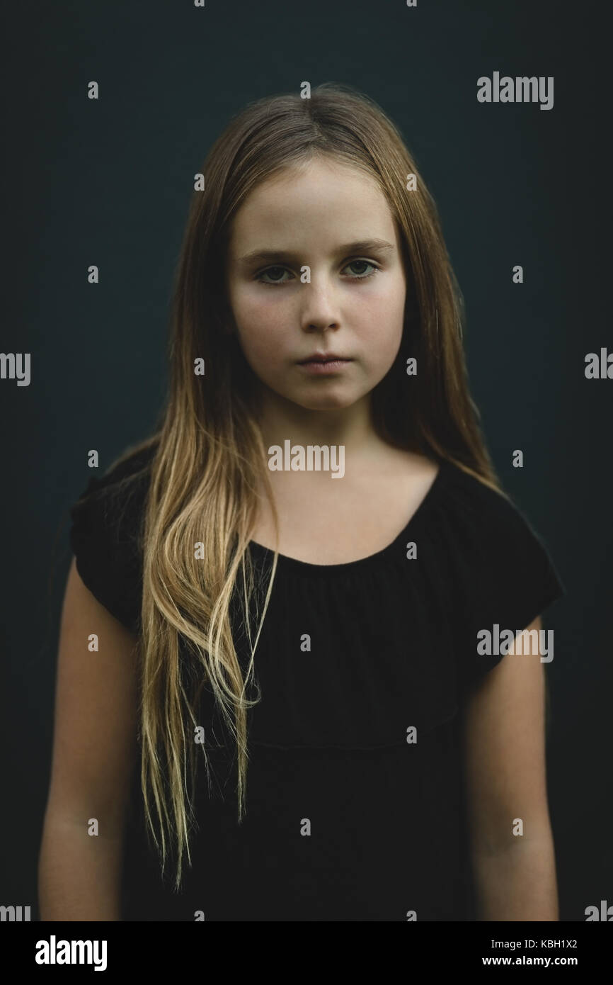 Portrait of girl against black background Stock Photo