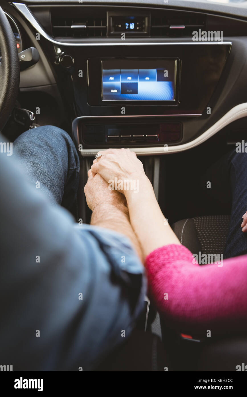 Romantic Couple Holding Hands While Driving Car Stock Photo Alamy