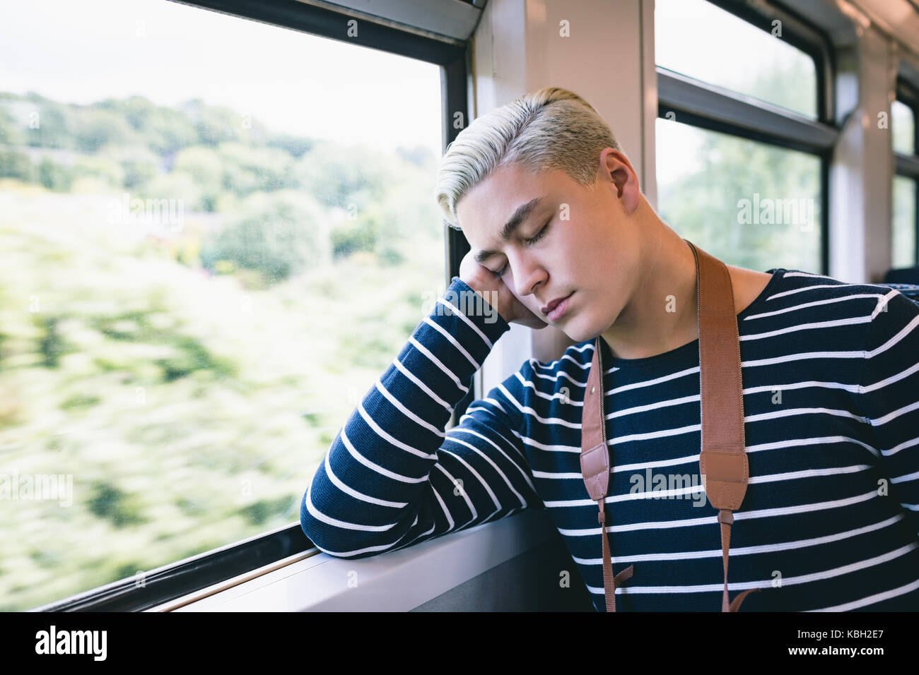 Man napping while travelling in metro Stock Photo