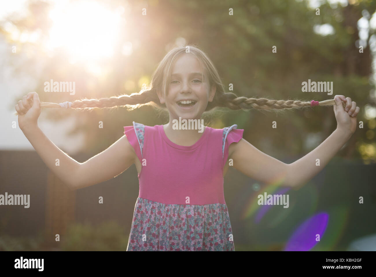 Girl playing with her hair in the park Stock Photo - Alamy