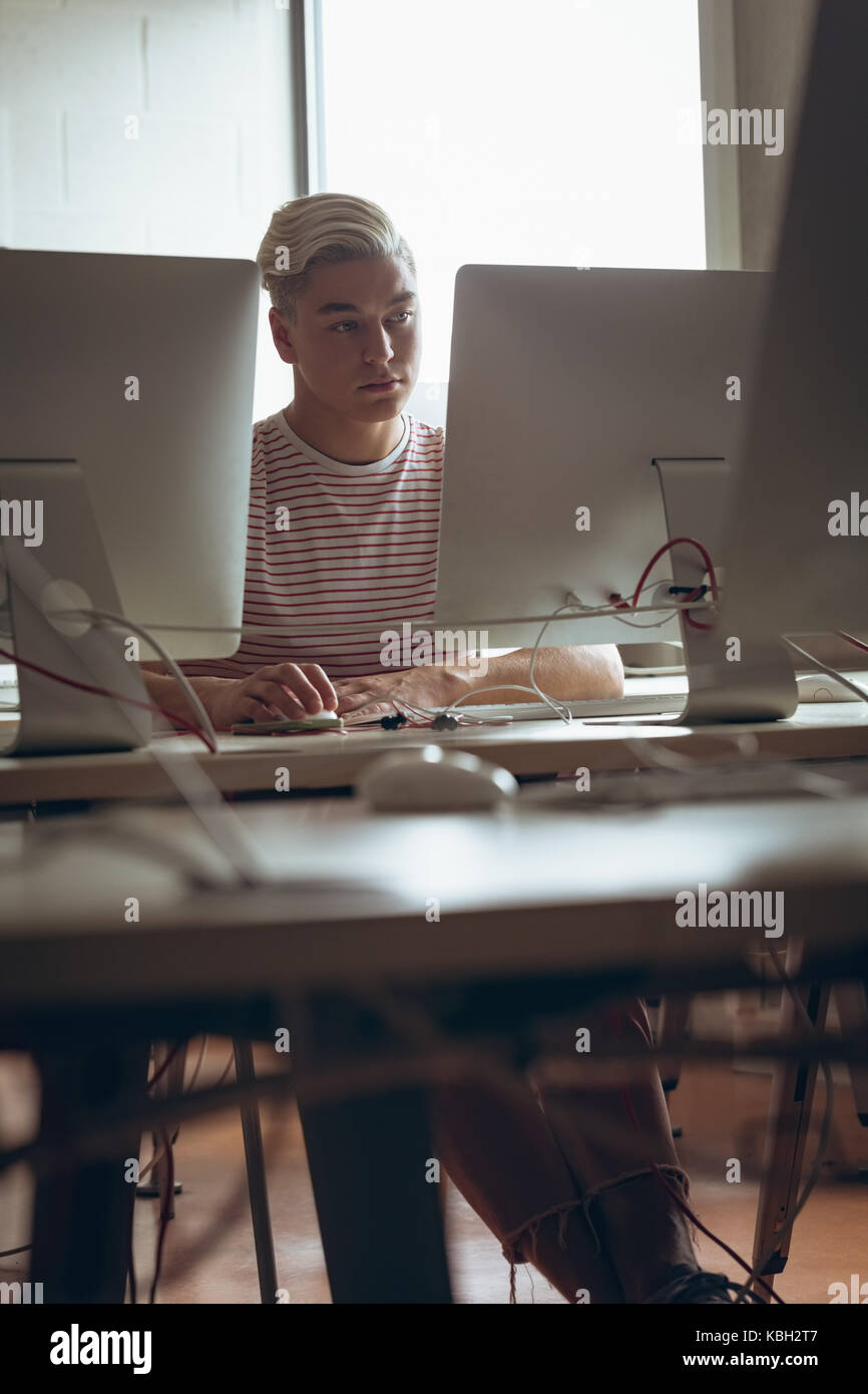 Man working on personal computer in office Stock Photo