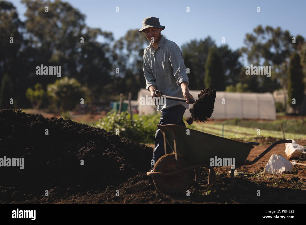 Farmer working in the field on a sunny fay Stock Photo - Alamy