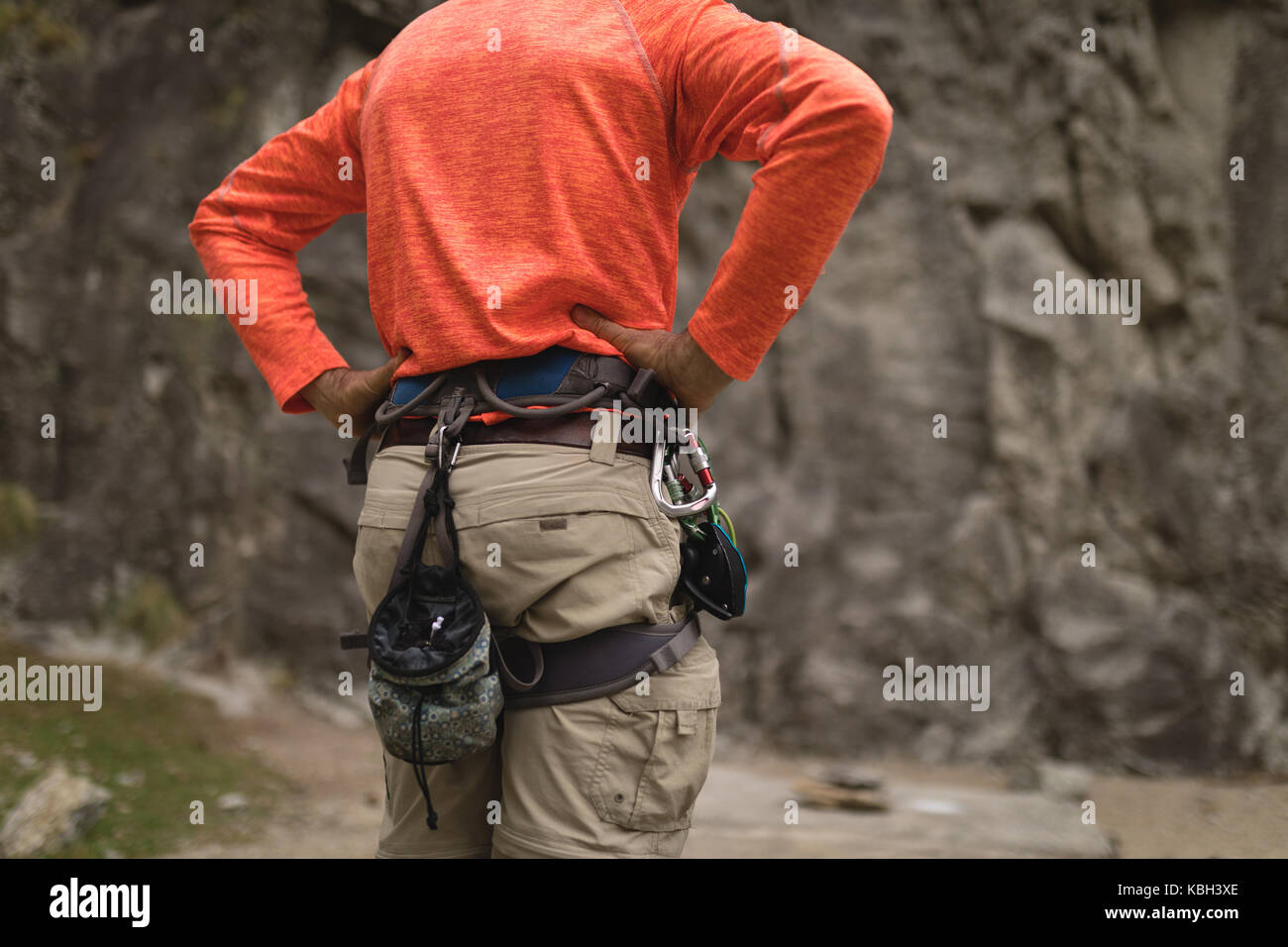 Mid section man wearing safety equipment during mountaineering Stock
