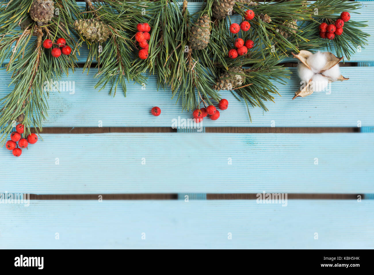 Christmas frame with fir tree branch on a handpainted blue wooden ...