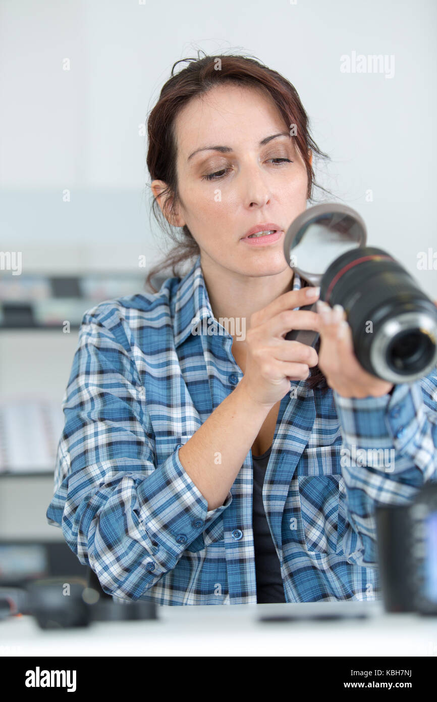 female photographer looking at zoom lens Stock Photo Alamy